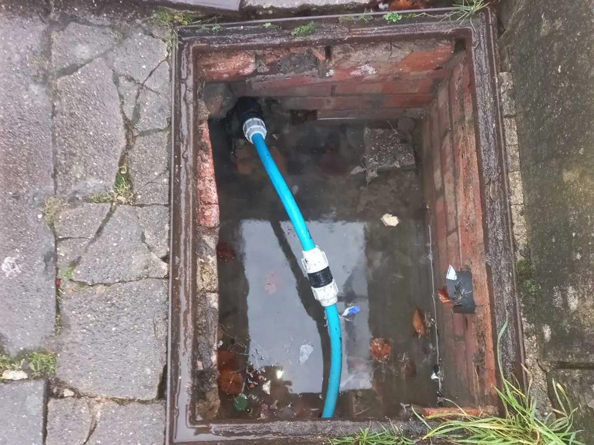 repair in progress with new 25mm blue mains pipe and coupling fitted inside access chamber