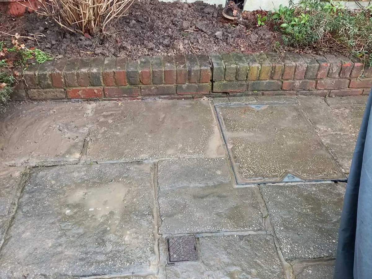 back garden patio and planted border reinstated after repair to underground mains