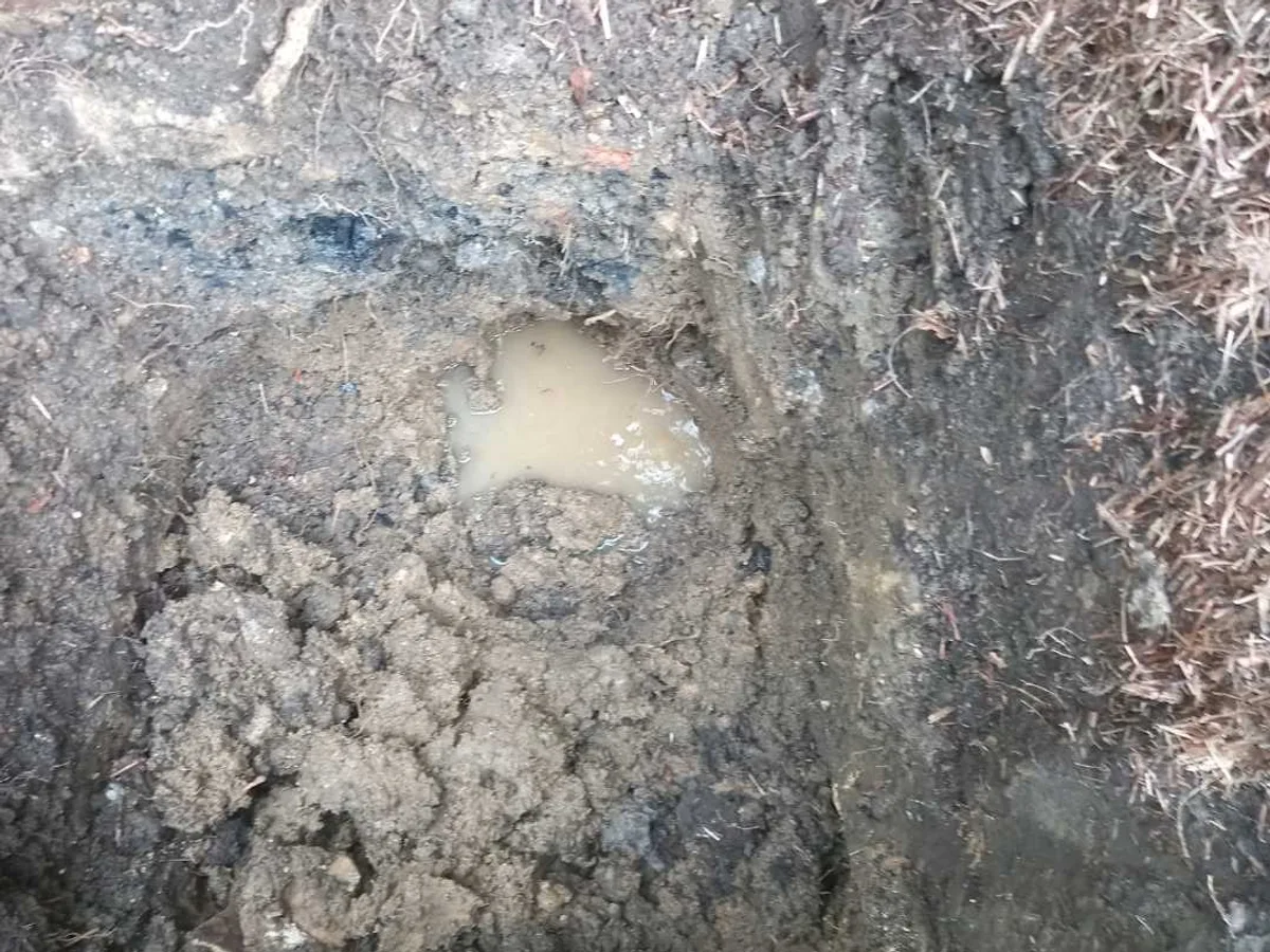 leak located at pooling water in excavated soil above underground mains pipe