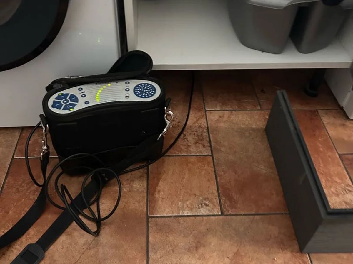 gas sniffer unit on kitchen floor tiles during leak detection beneath suspended floor
