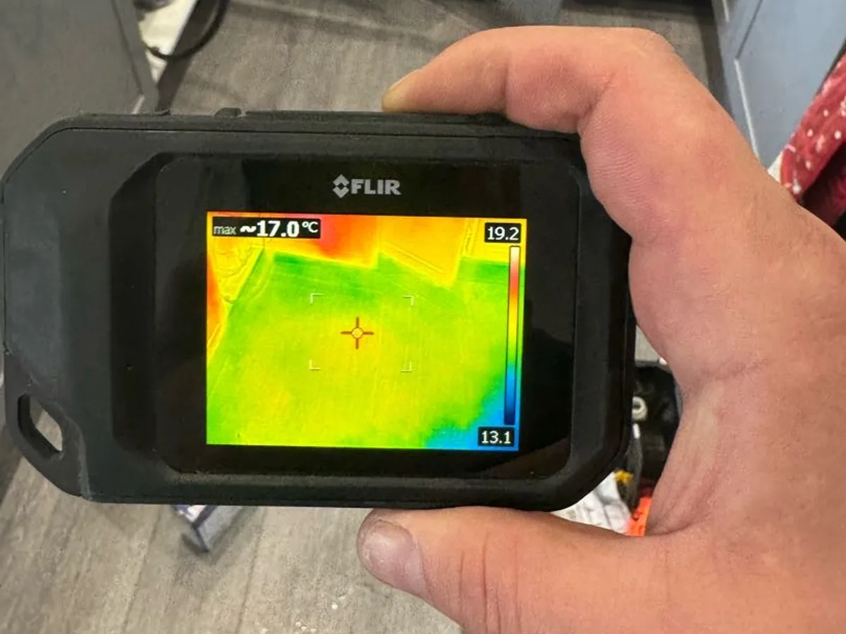 thermal imaging camera scanning kitchen floor during leak detection survey