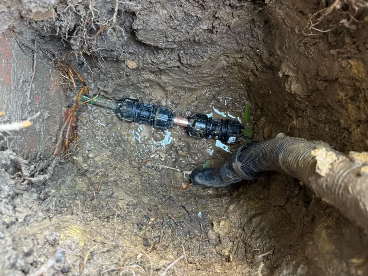 new push-fit couplings installed on underground mains pipe as repair completed