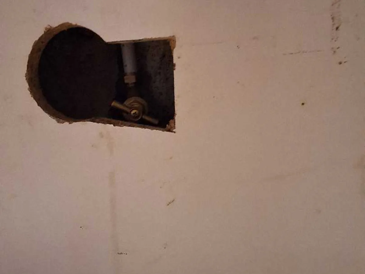internal stopcock accessed through wall opening during leak detection investigation