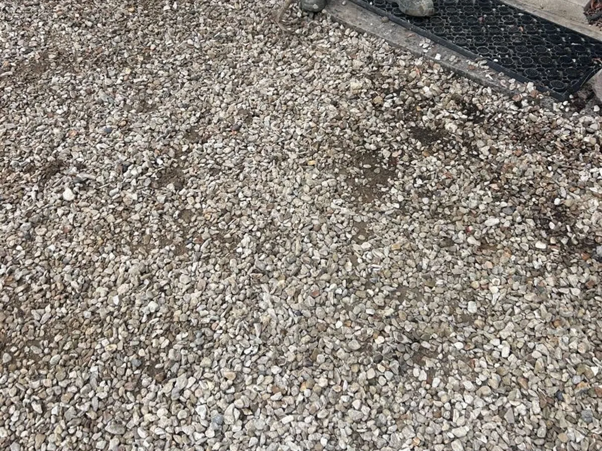 gravel driveway raked level and area reinstated after repair to underground mains
