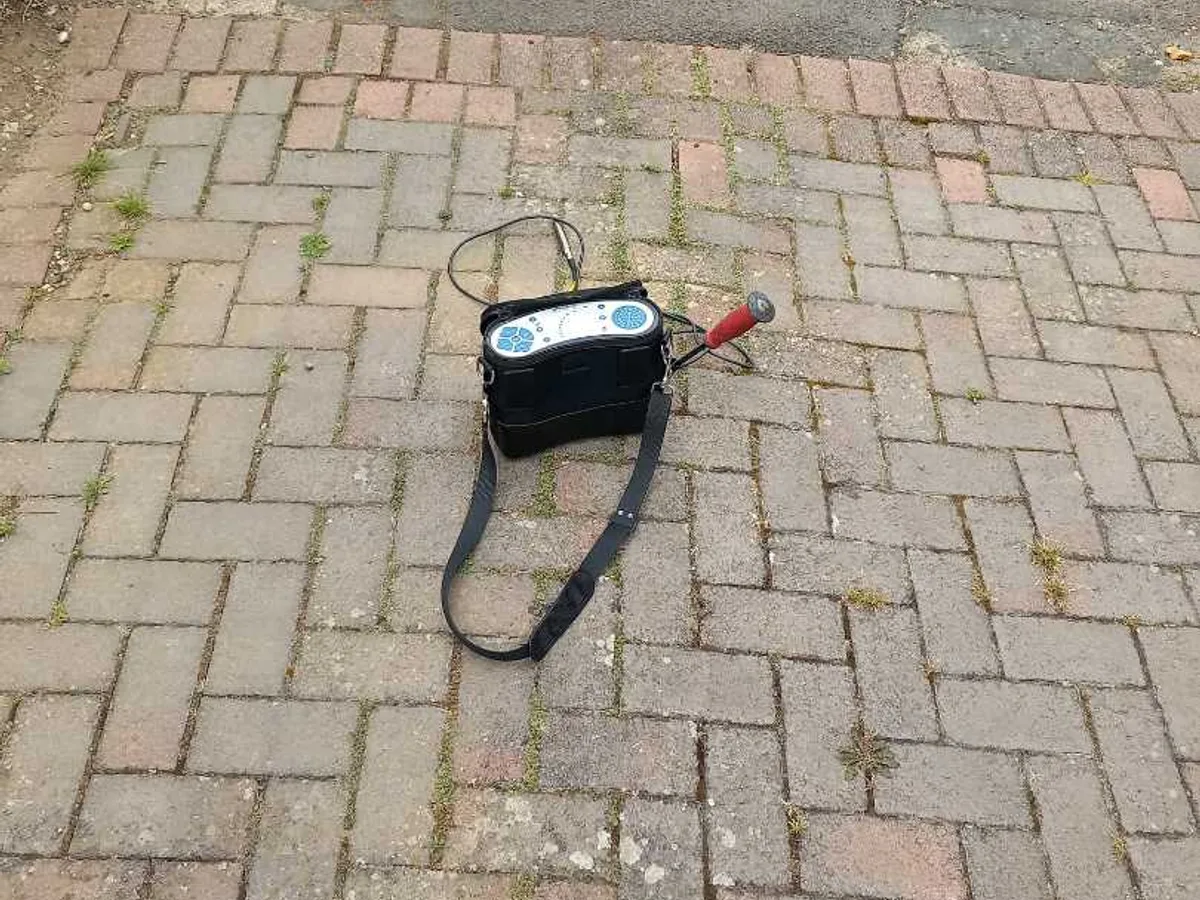 acoustic listening device placed on brick paving driveway during leak detection survey