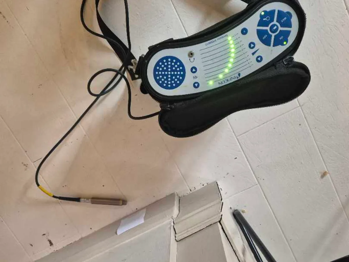 acoustic listening device placed on lounge floor during leak detection survey