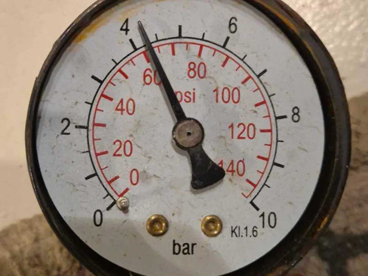 pressure gauge showing elevated mains supply pressure during leak detection investigation