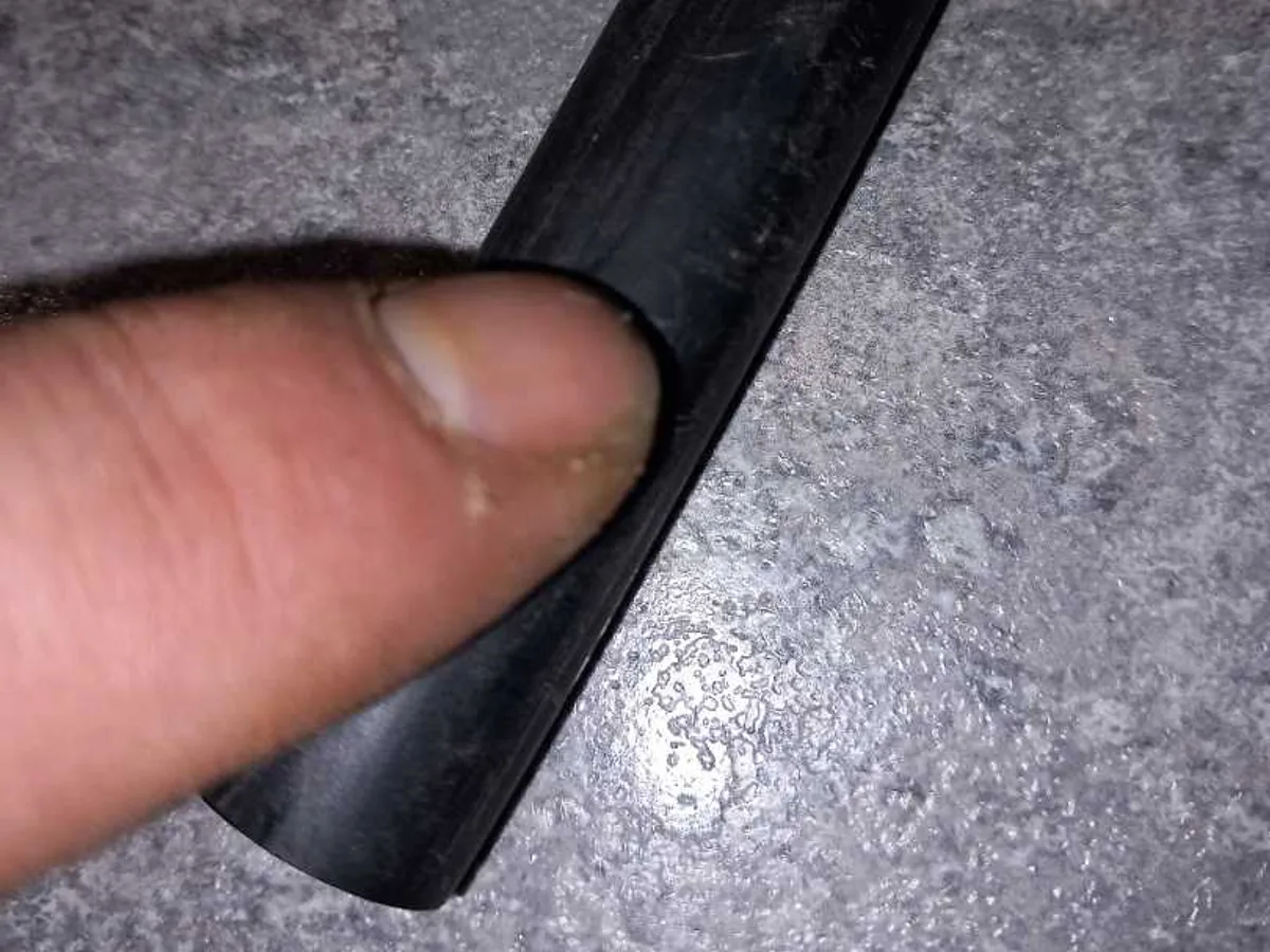 fault identified at section of old black plastic mains pipe crushed by timber — leak located at