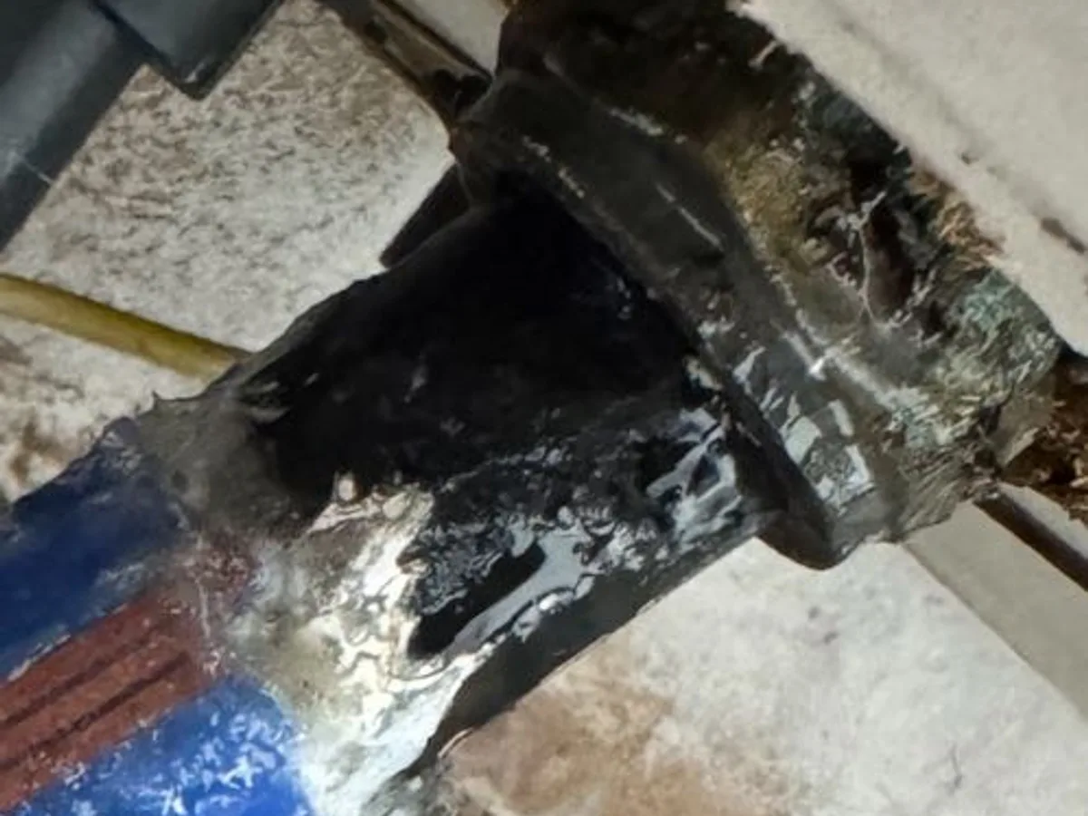 fault exposed at stopcock connection entering duct beneath kitchen kickboard