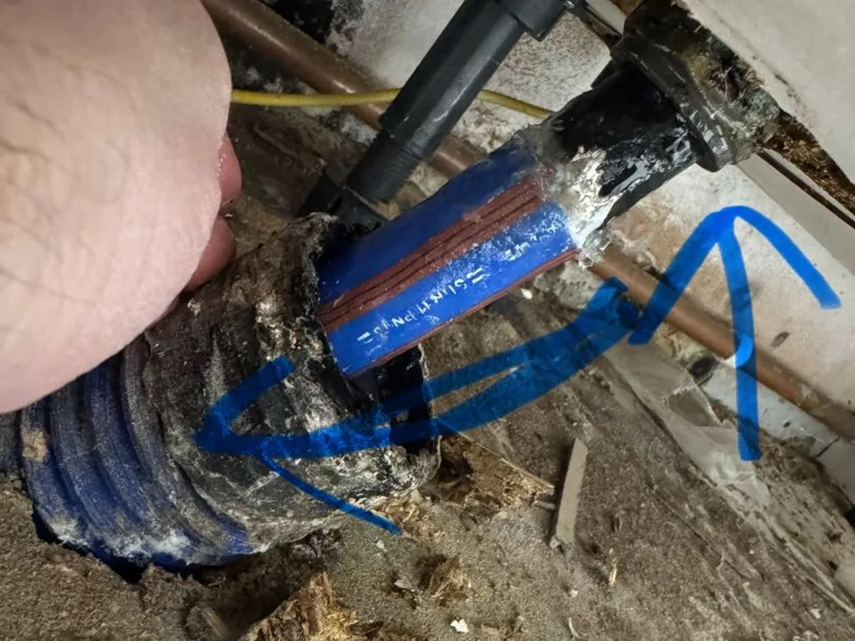 leak located at stopcock joint onto black plastic mains pipe beneath kitchen units