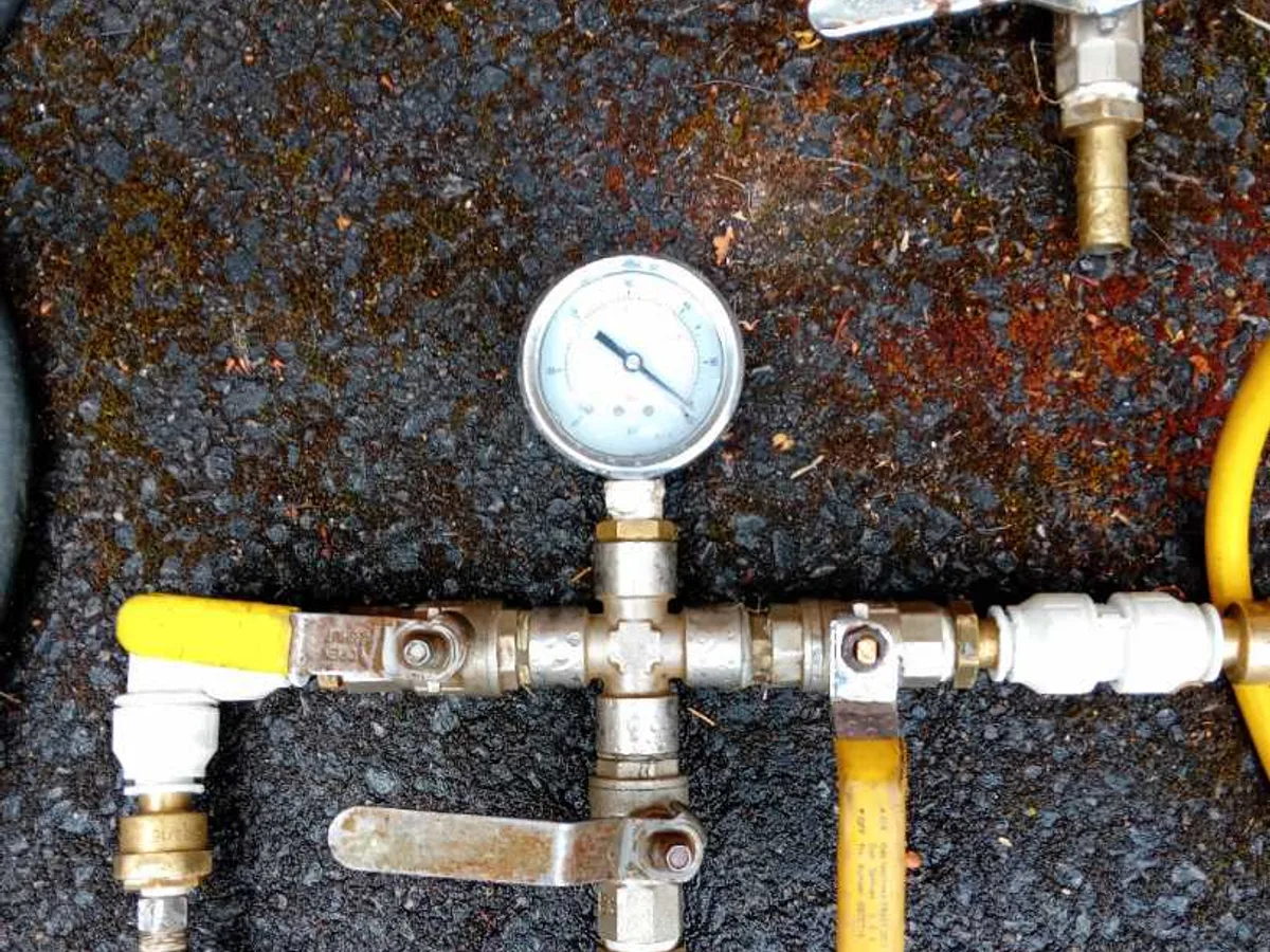 pressure test manifold and gauge connected to pipework during leak detection survey
