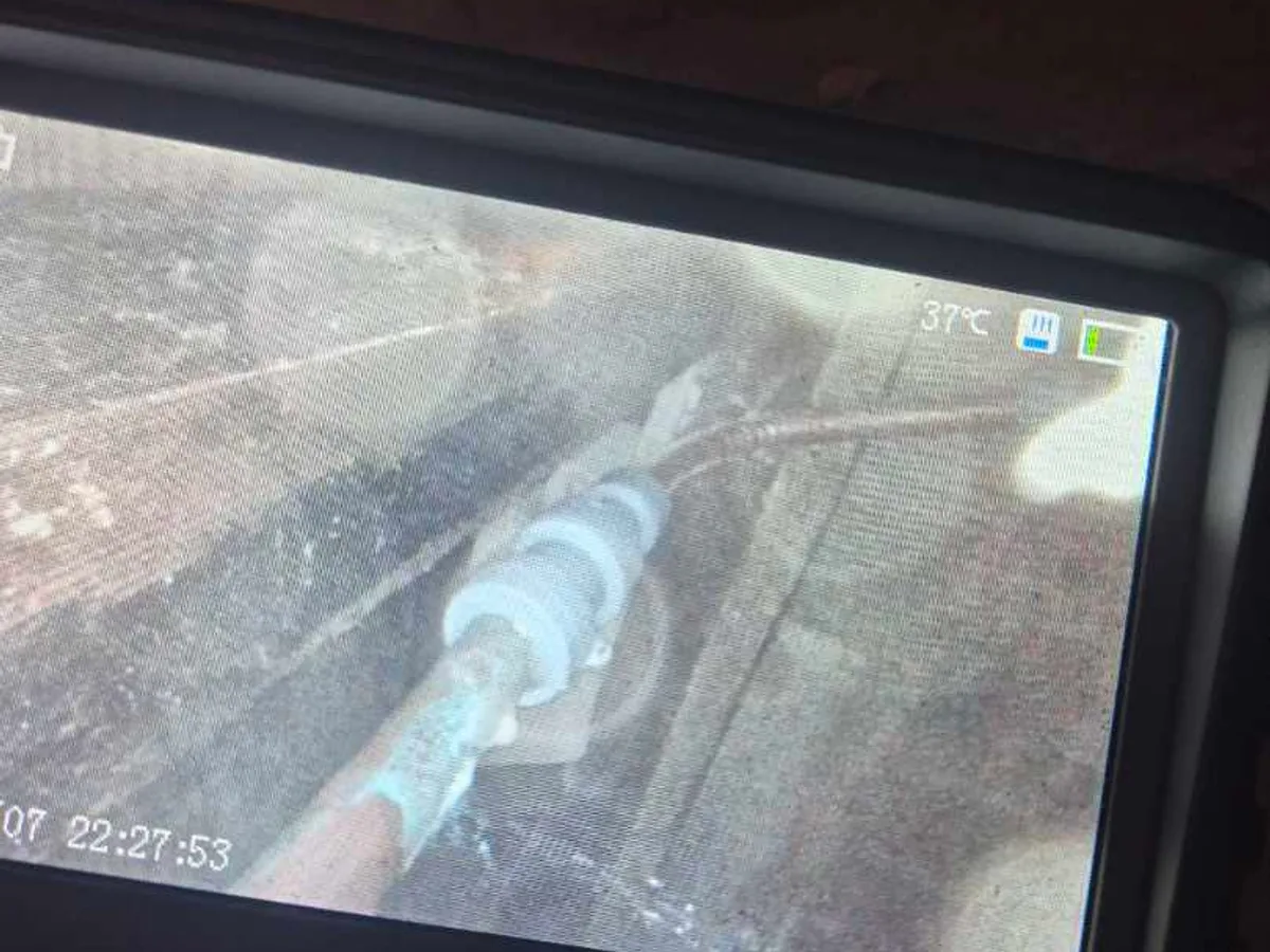 endoscope camera screen showing pipework beneath bathroom floor during leak detection