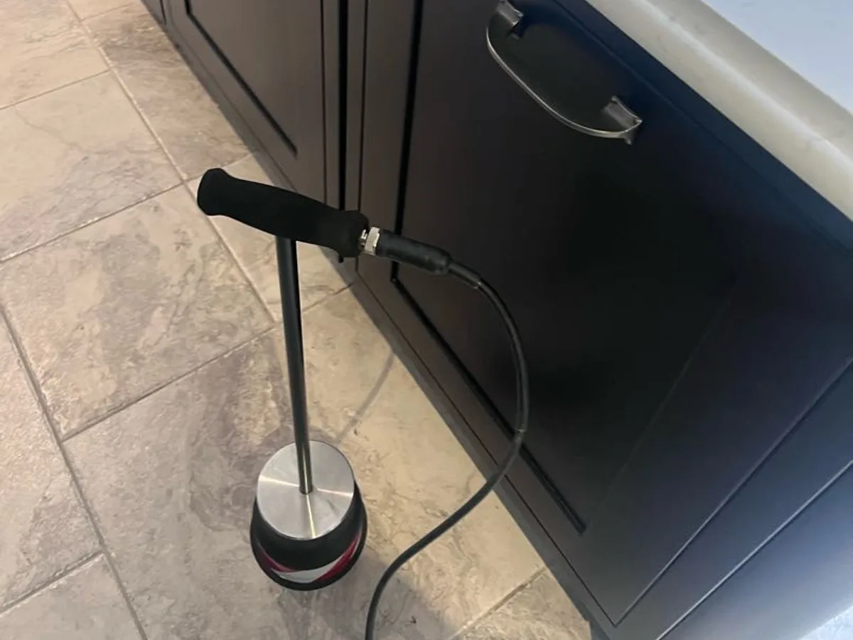 acoustic listening probe placed at kitchen island floor during leak detection