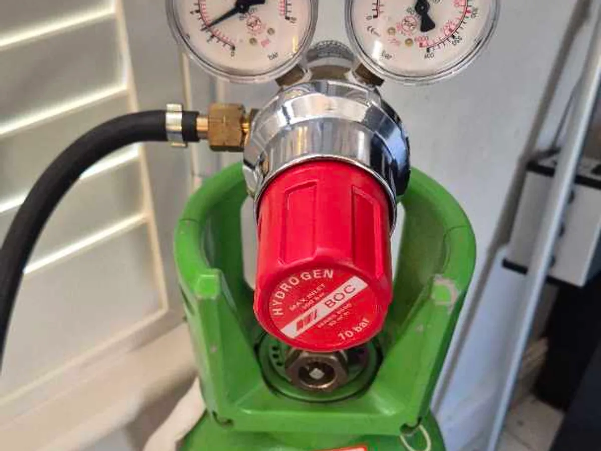 dual-gauge regulator on tracer gas cylinder in use during investigation