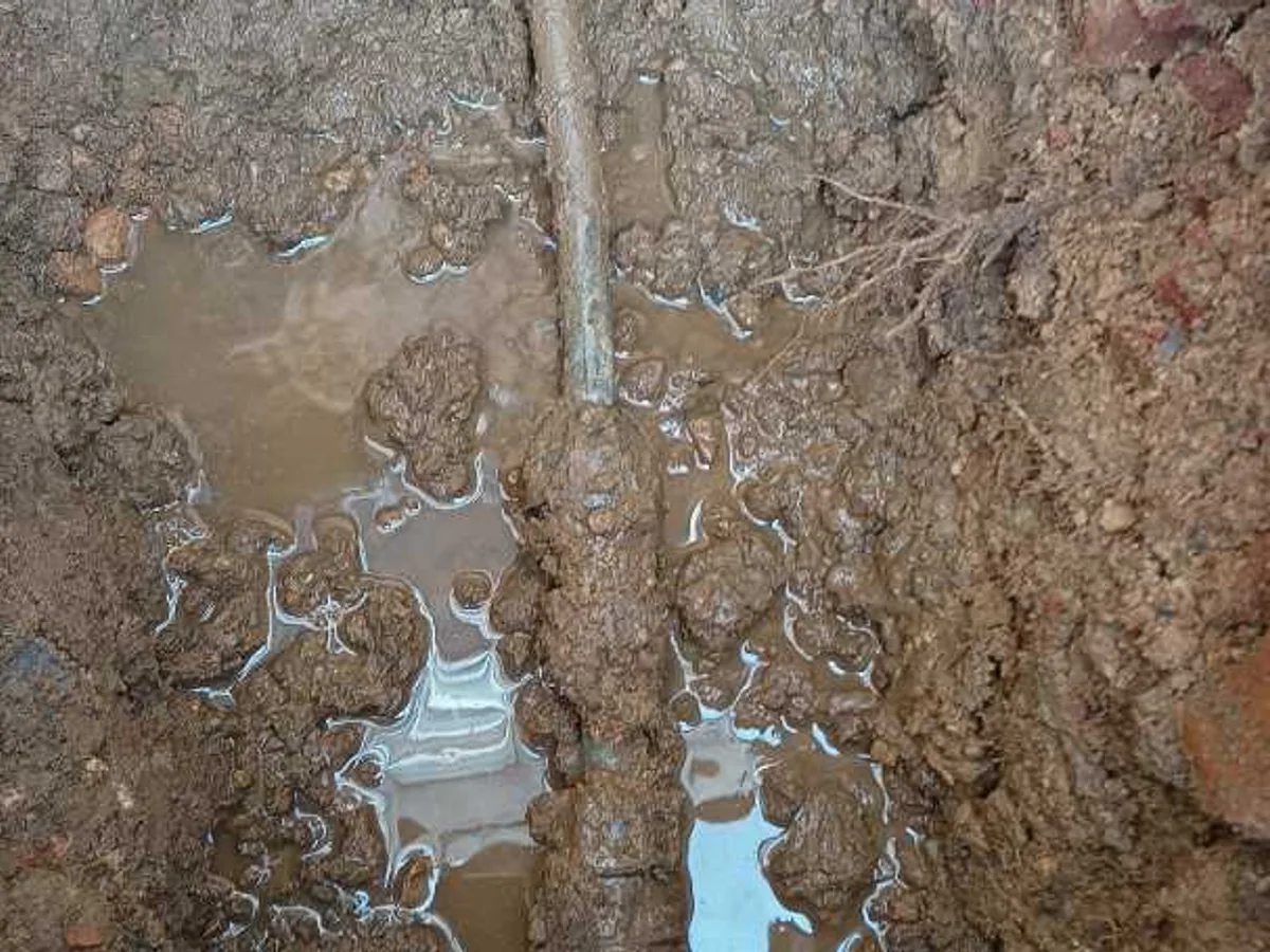 leak located at previous repair coupling on lead pipework in waterlogged excavation trench