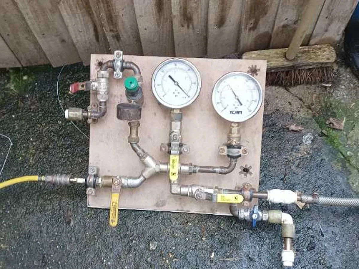dual-gauge pressure test kit on board in use during leak detection survey
