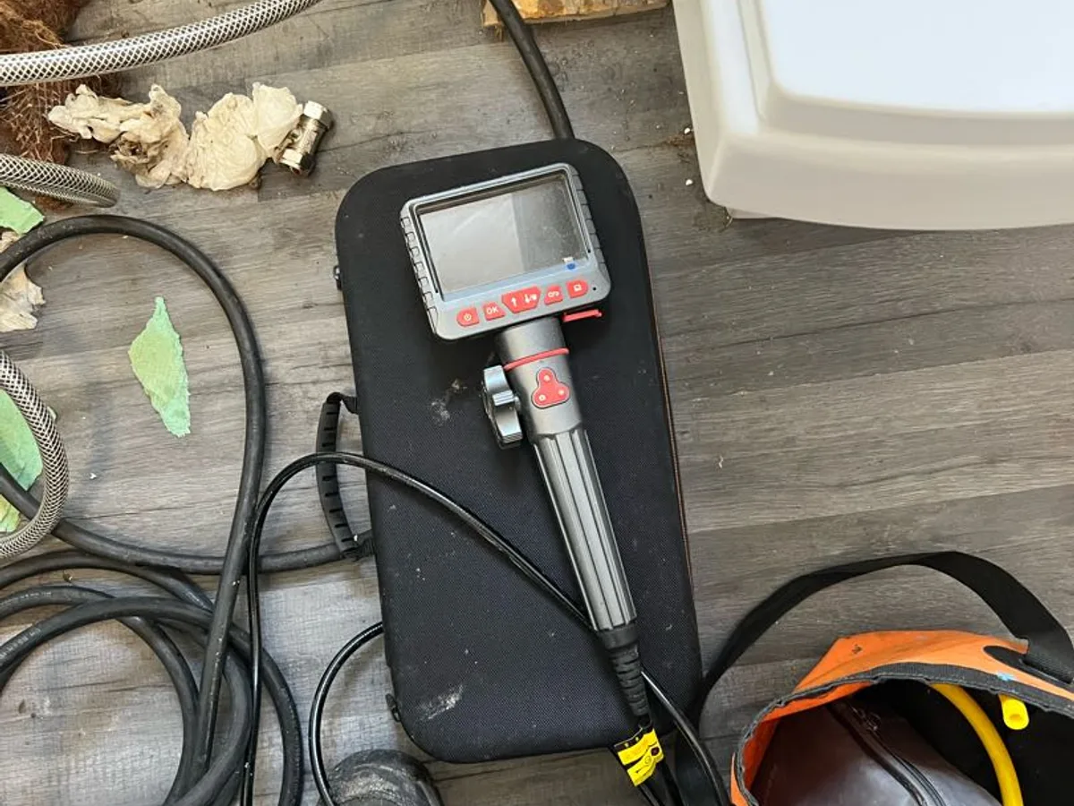 endoscope camera unit laid out on bathroom floor in use during investigation