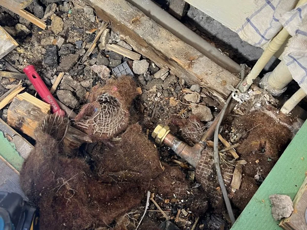 leak located at subfloor void with heavily saturated fibrous debris around copper pipework