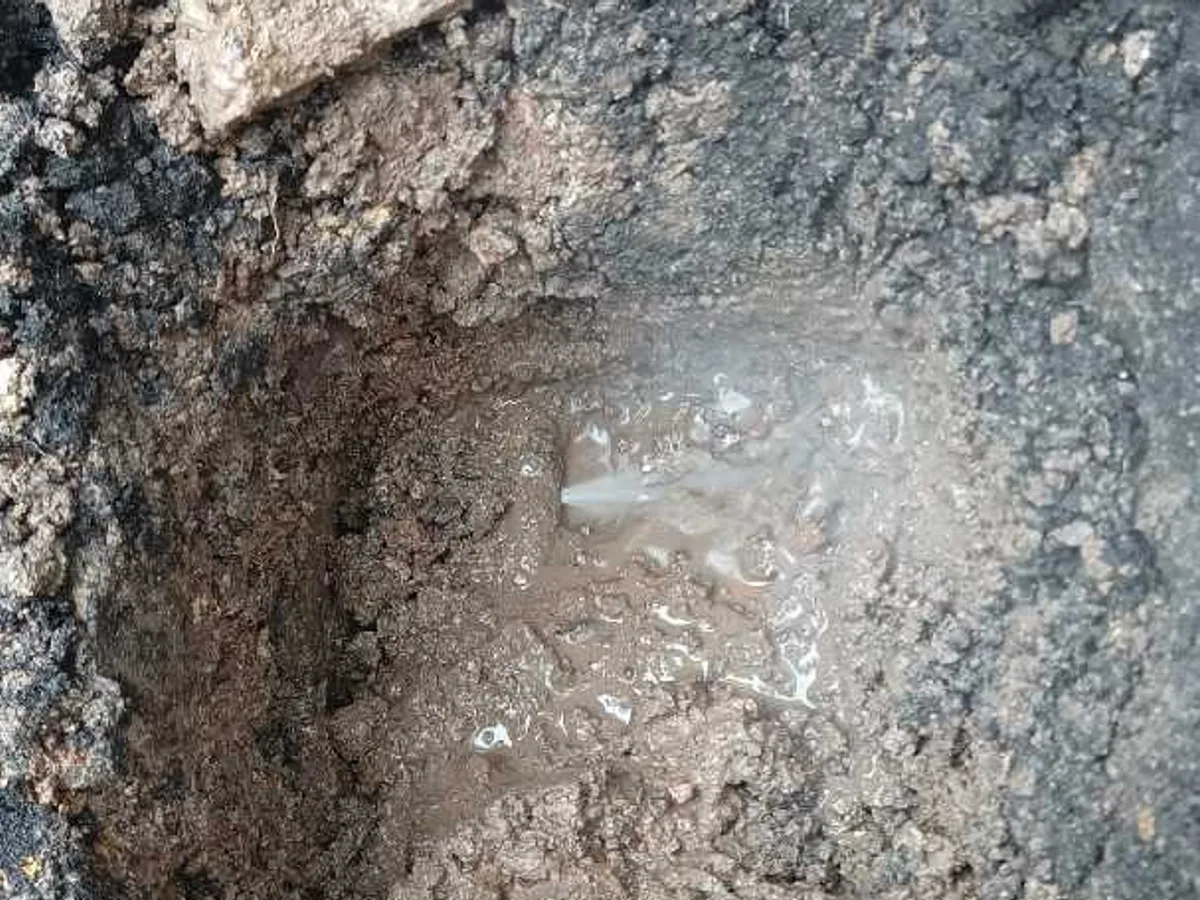 leak found at split lead mains pipe in waterlogged soil below paving