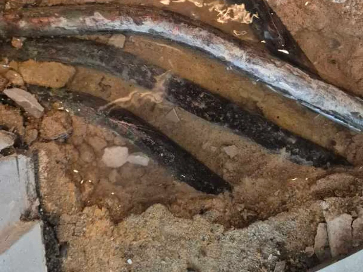 leak found at waterlogged copper pipes in saturated screed beneath tiled floor