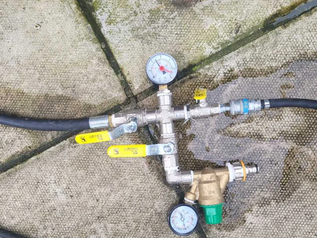 pressure test rig with gauges and isolation valves on paving during leak detection