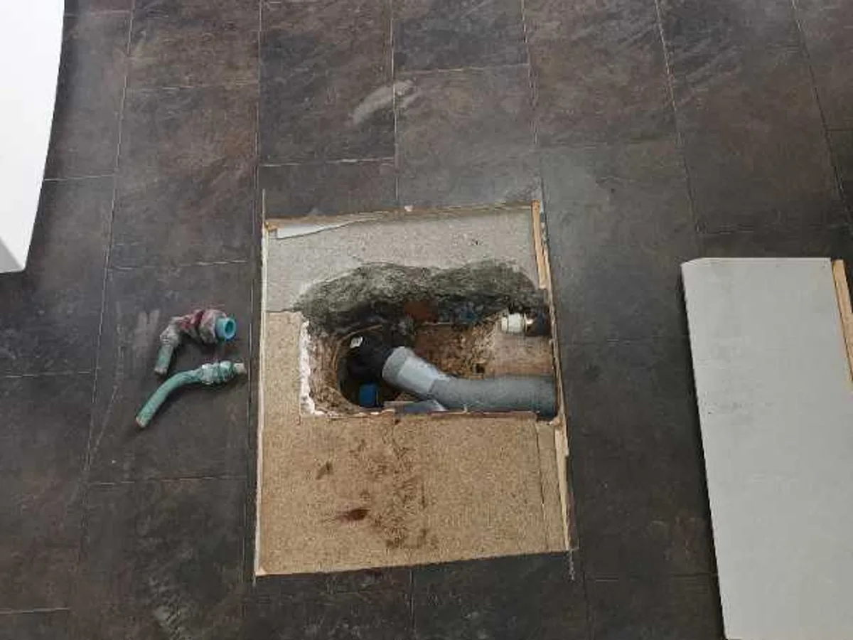 replacement Philmac fittings installed on cold mains pipework beneath kitchen floor after repair completed