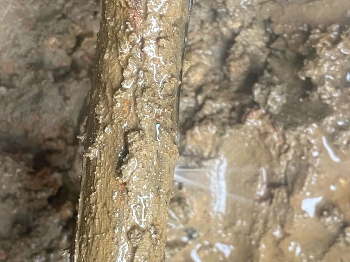 leak located at corroded thin-wall steel mains pipe with lateral fracture exposed underground