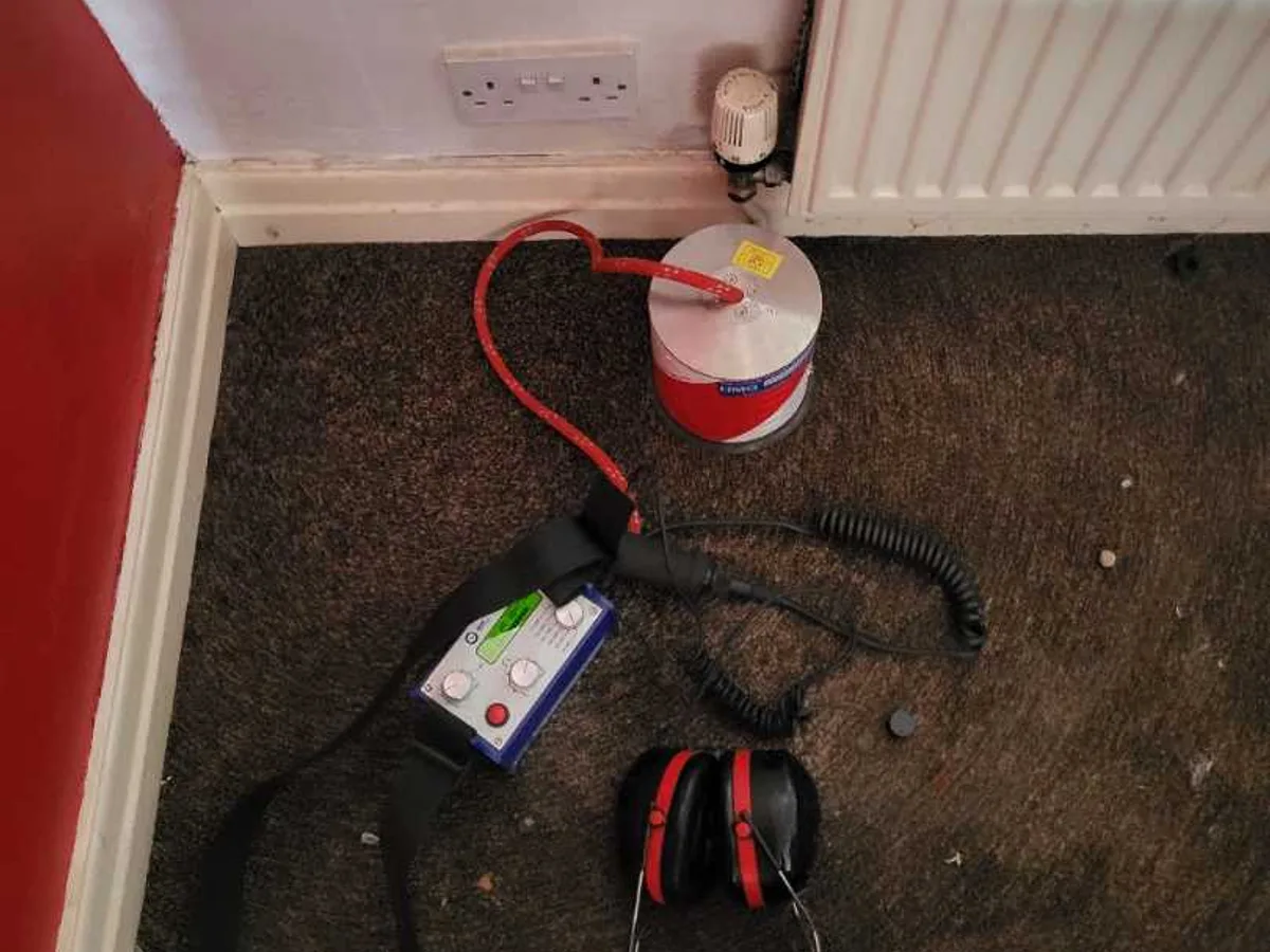 acoustic listening unit and headphones on lounge carpet during leak detection