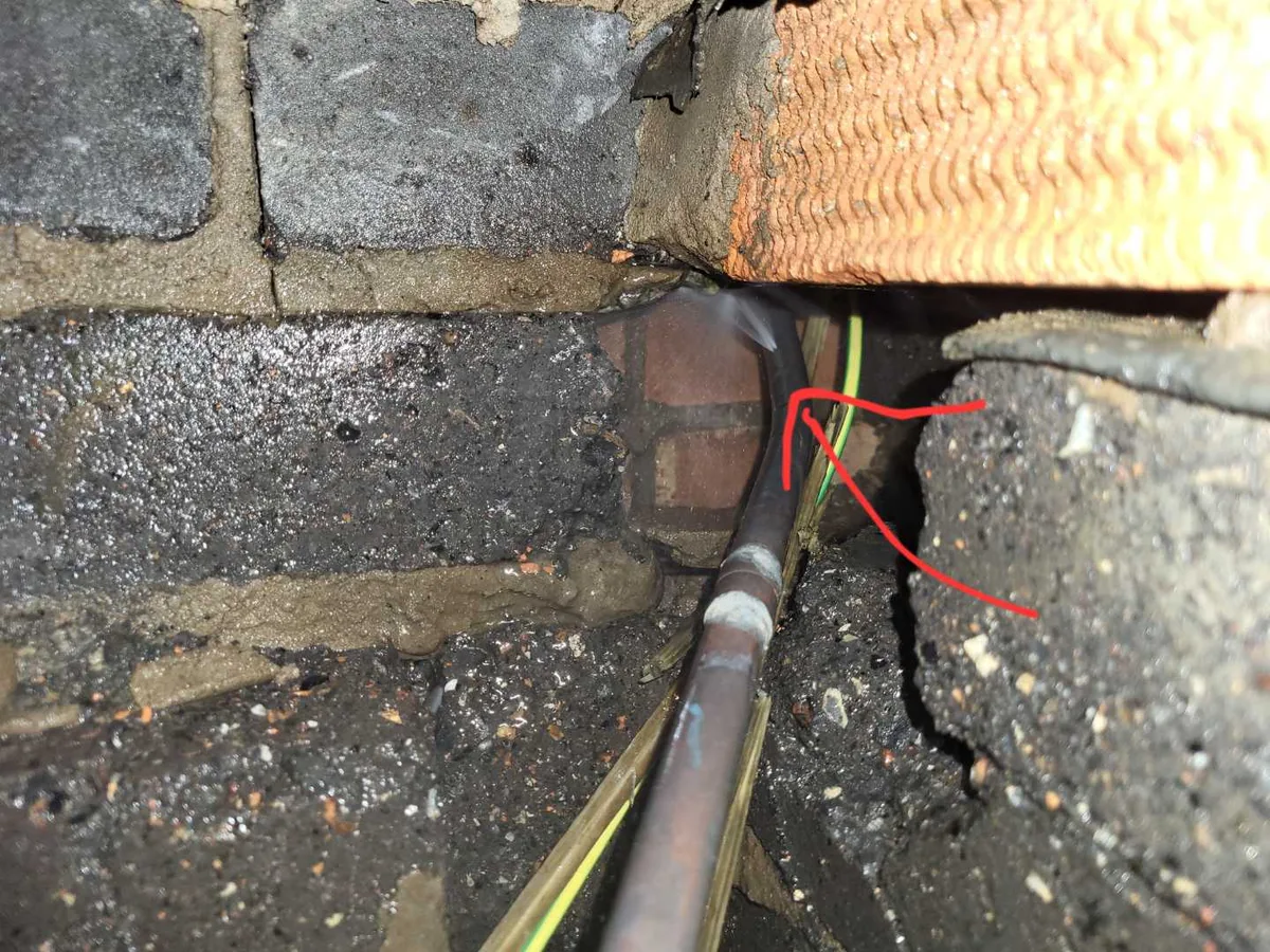 fault identified at copper mains pipe passing through saturated subfloor void beneath lounge — leak located at