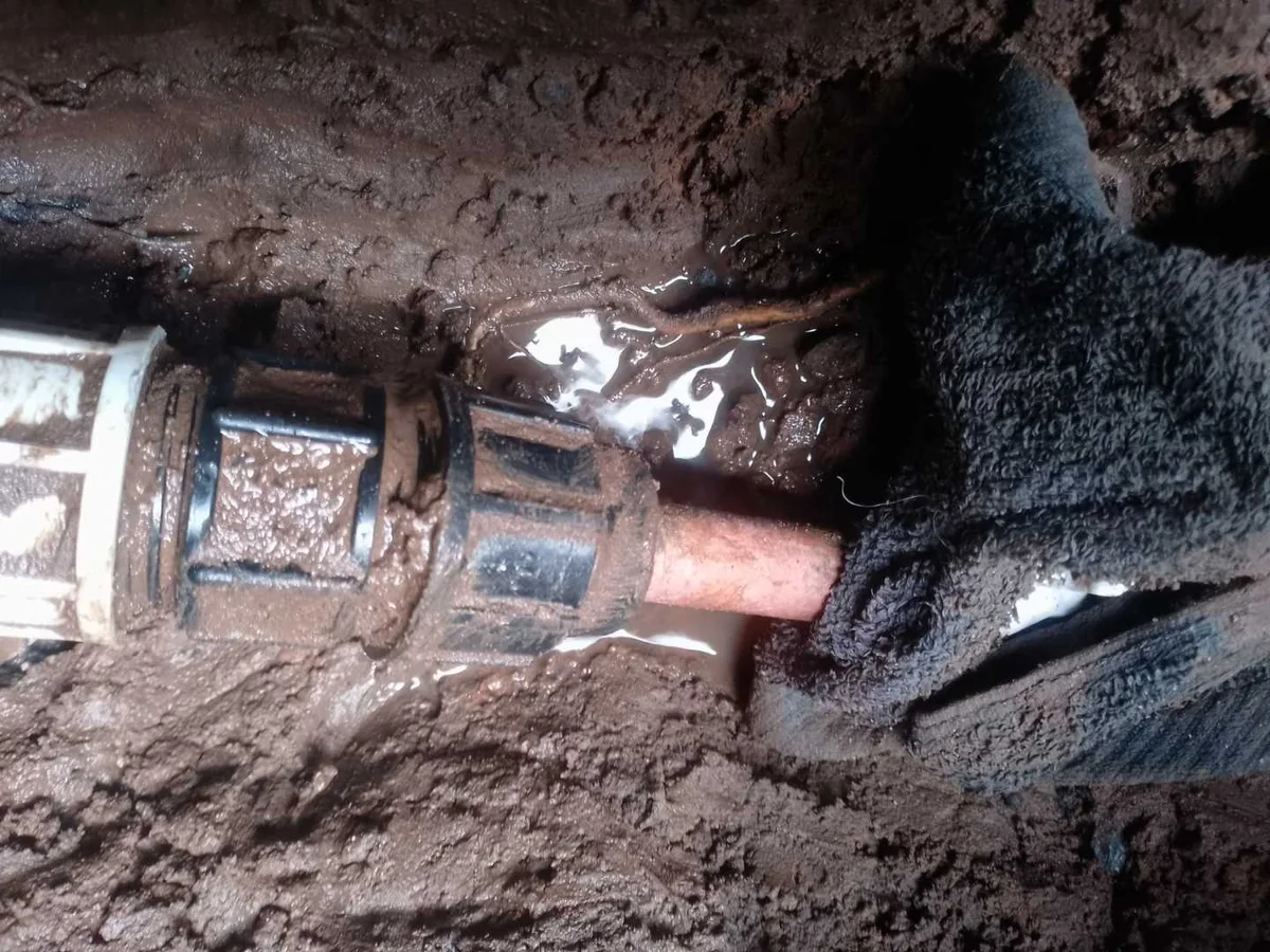 leak located at cross-threaded underground mains fitting exposed in excavation