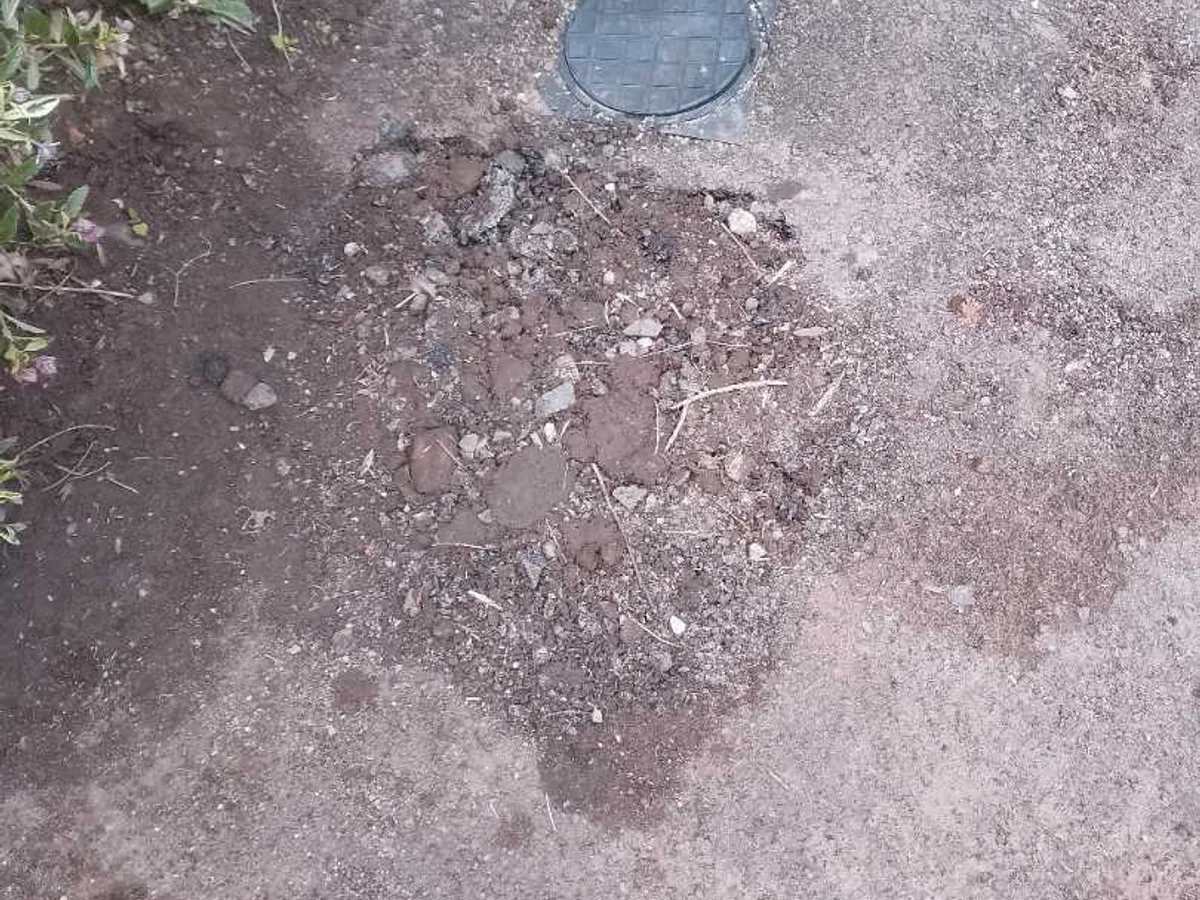 driveway excavation backfilled and area reinstated after repair beside external meter
