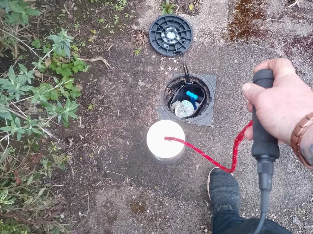 tracer gas probe inserted into open water meter box during leak detection survey