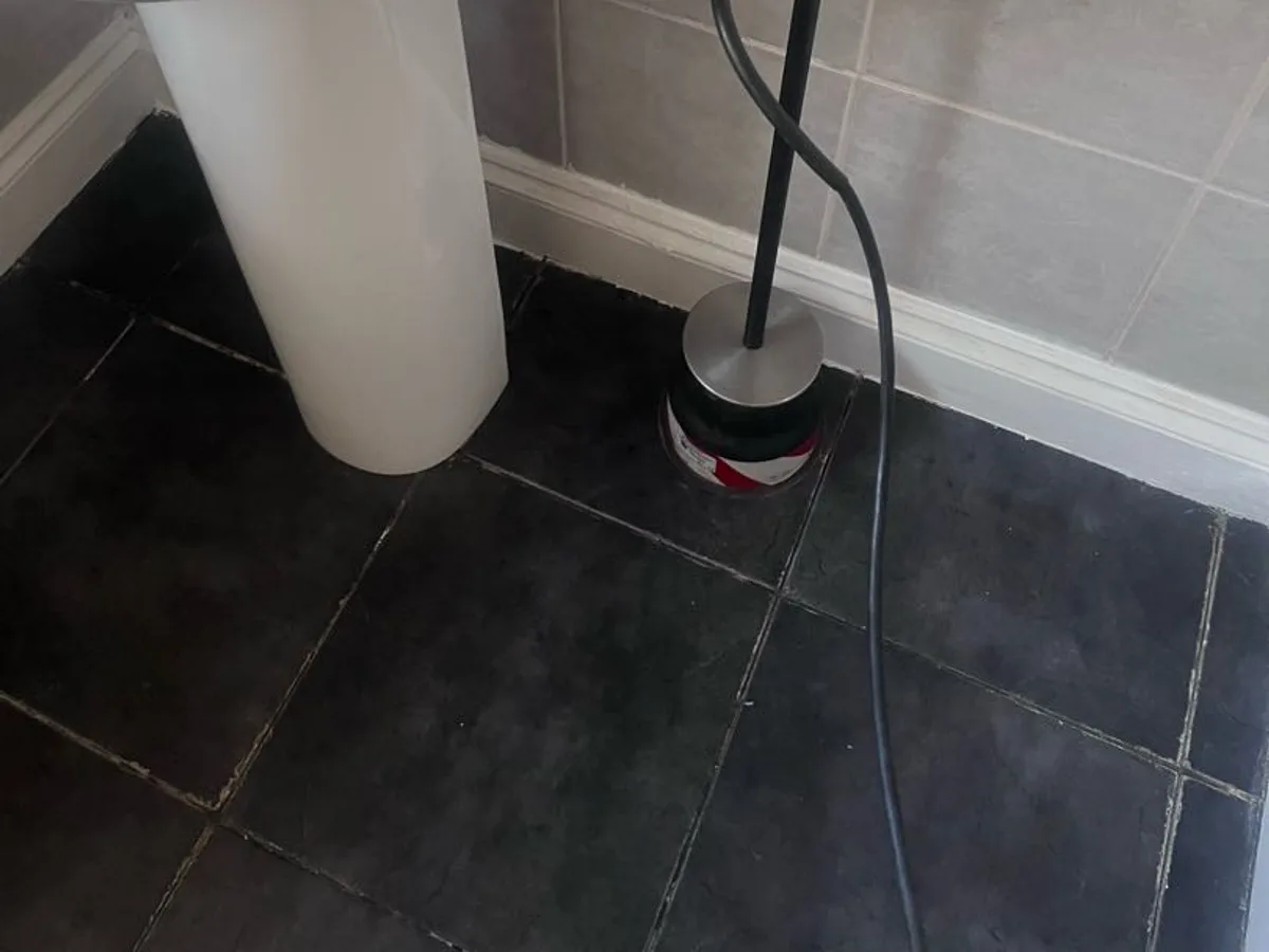 acoustic listening device placed on tiled floor beneath basin during leak detection