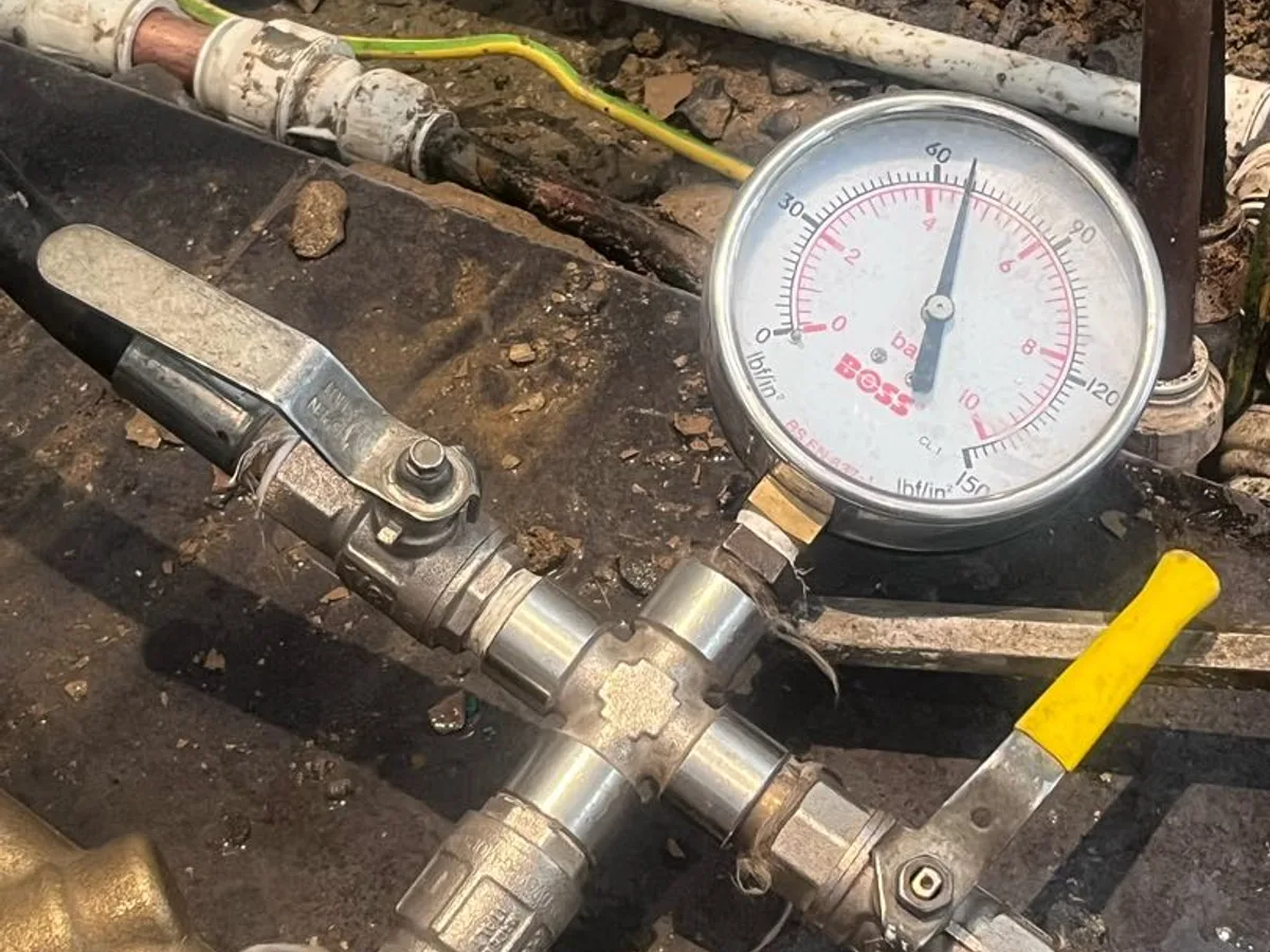 pressure gauge connected to repaired pipework while testing during investigation