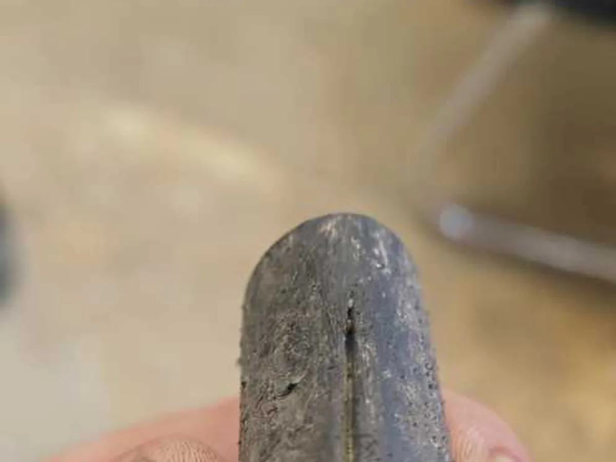 fault identified at flattened brittle MDPE mains supply pipe section removed from excavation — leak located at