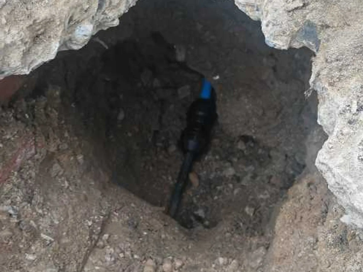 new MDPE pipe laid in excavation as underground mains repair in progress