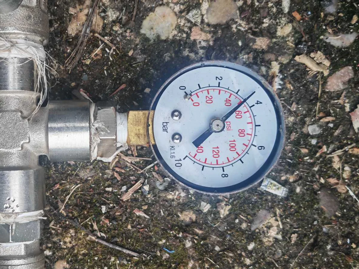 pressure gauge on repaired mains supply after works completed confirming sound supply