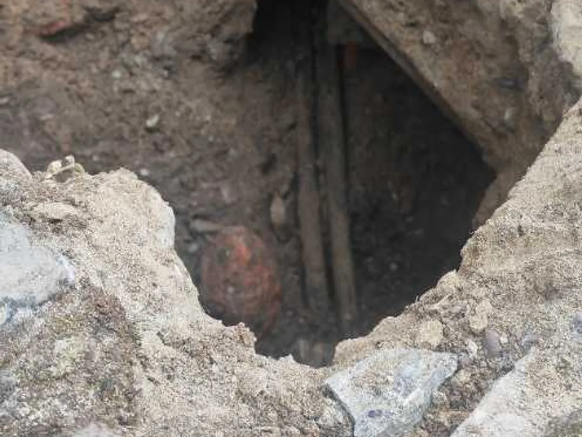 leak located at exposed underground mains pipework below cobbles beneath drain