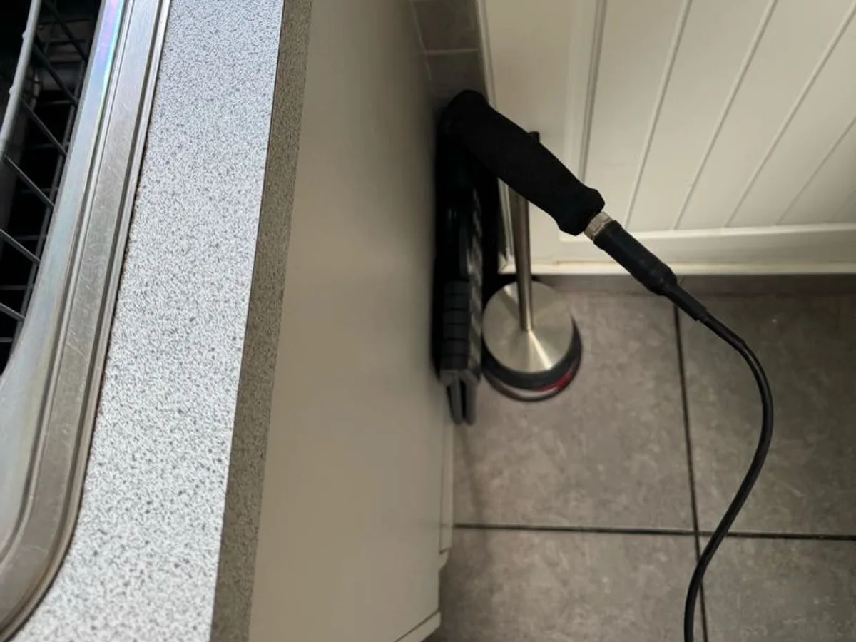 acoustic listening probe placed at floor level in utility room during leak detection