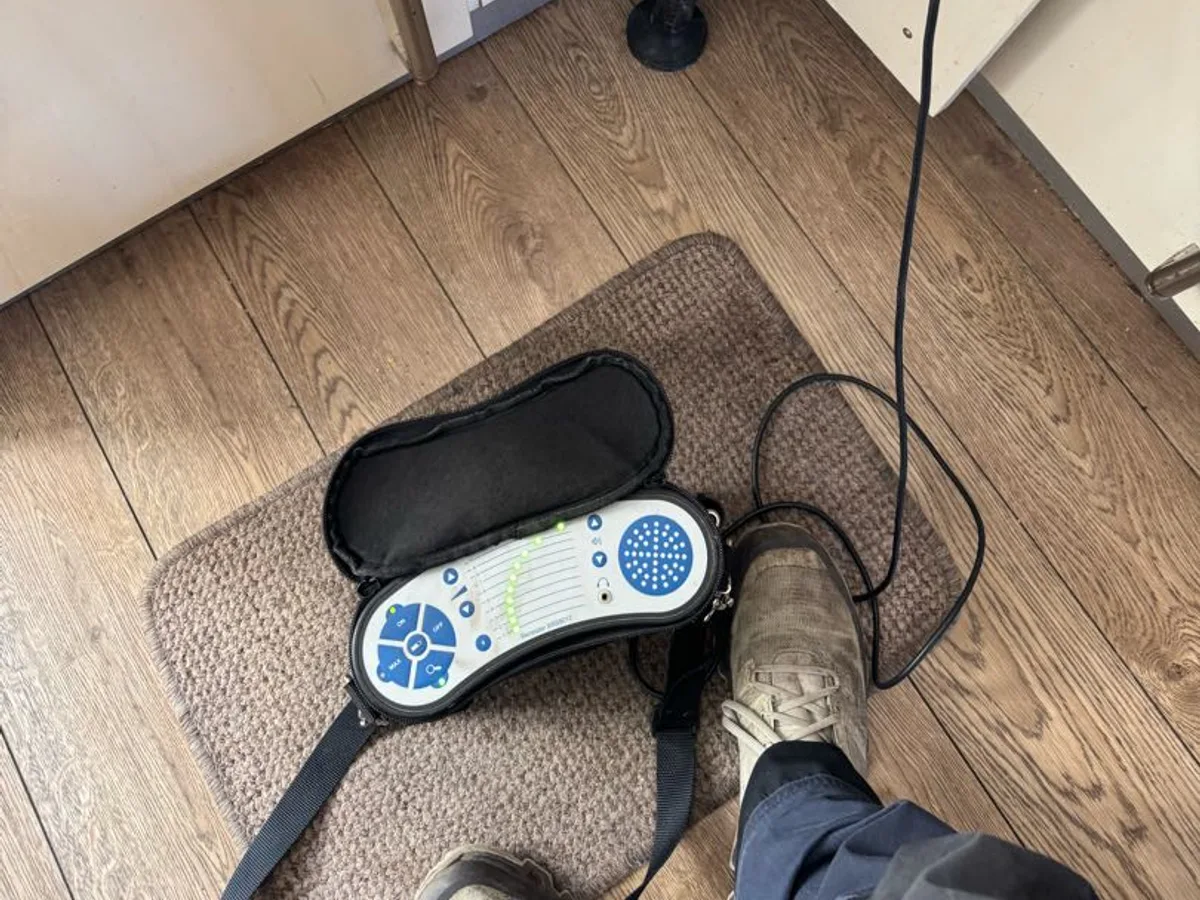 acoustic listening equipment placed at kitchen cupboard floor during leak detection