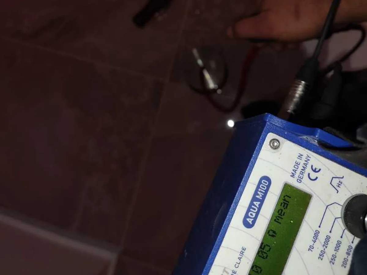 acoustic listening device placed on bathroom floor tiles during leak detection survey
