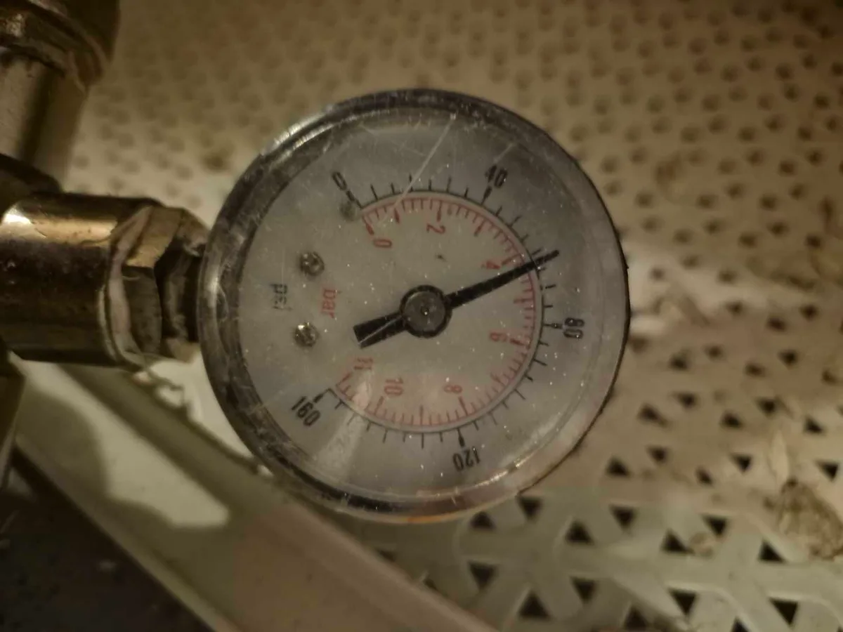 pressure gauge reading on external water mains pipe during leak detection