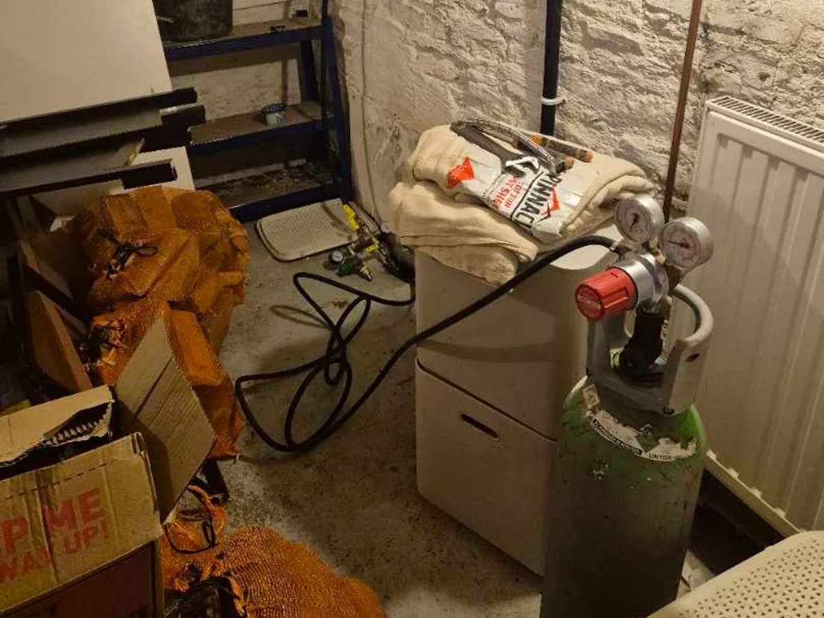 tracer gas cylinder connected to water mains pipework in basement during leak detection