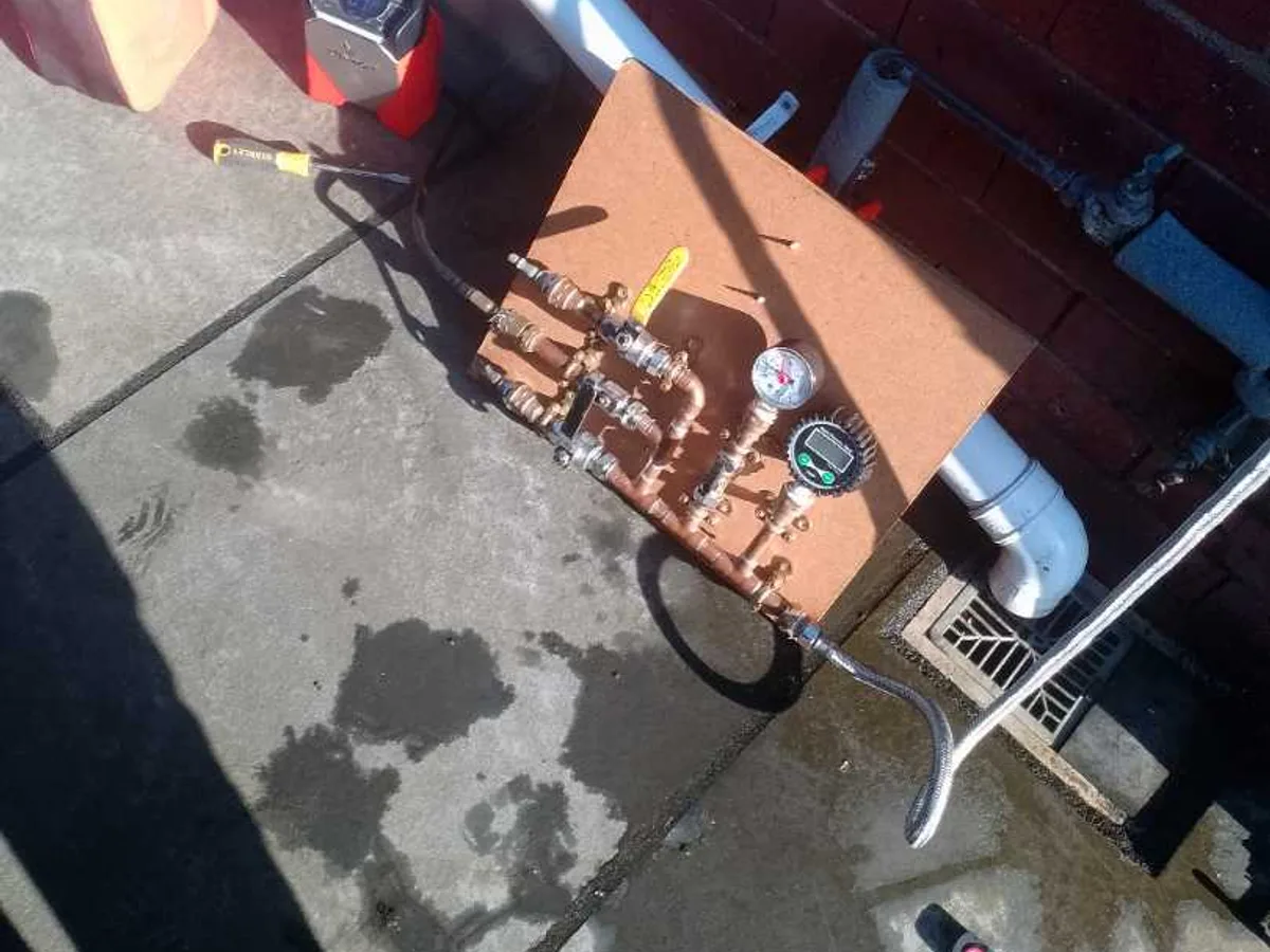pressure test manifold and gauge connected to outside tap during leak detection
