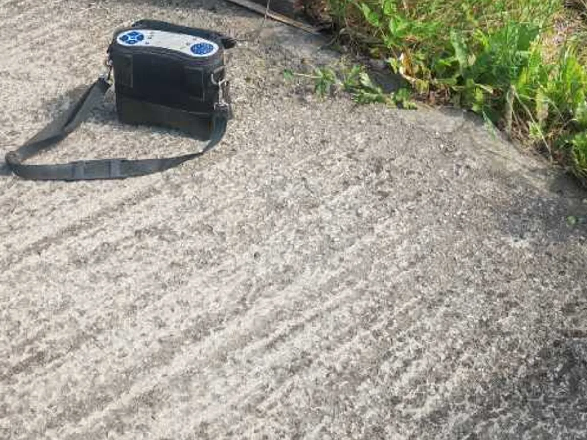 tracer gas analyser on driveway beside external stopcock during leak detection