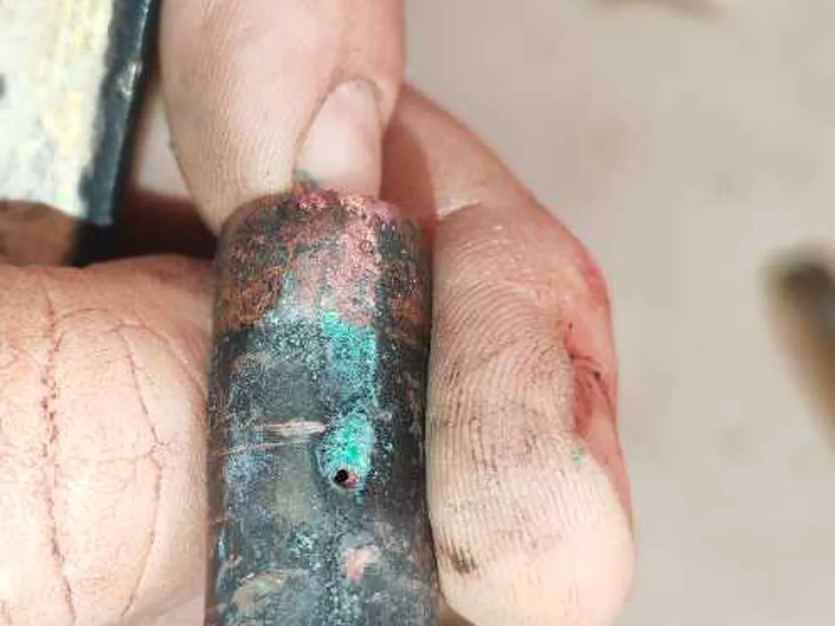 push-fit coupler joining copper and blue mains pipe after repair completed below floor