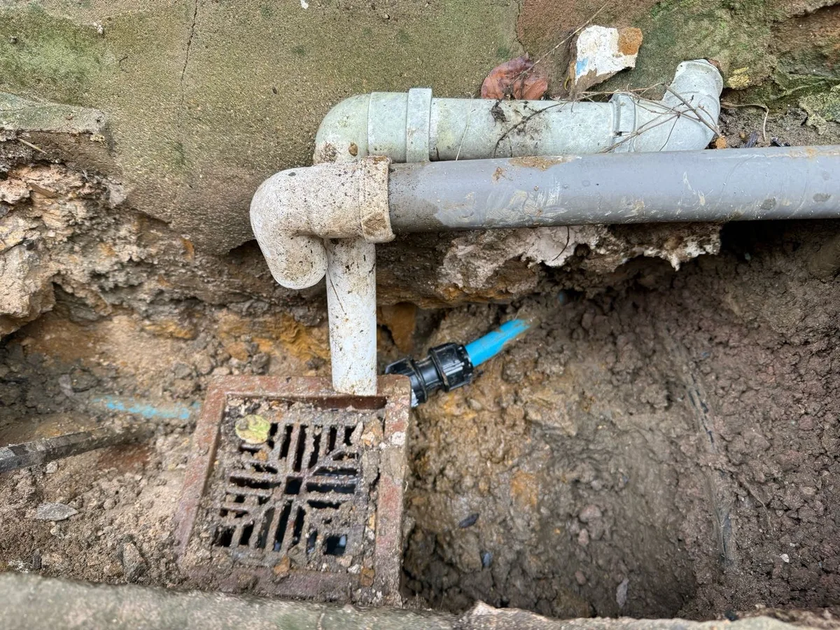 repair completed using compression coupling on 25mm blue MDPE mains pipe beside surface drain
