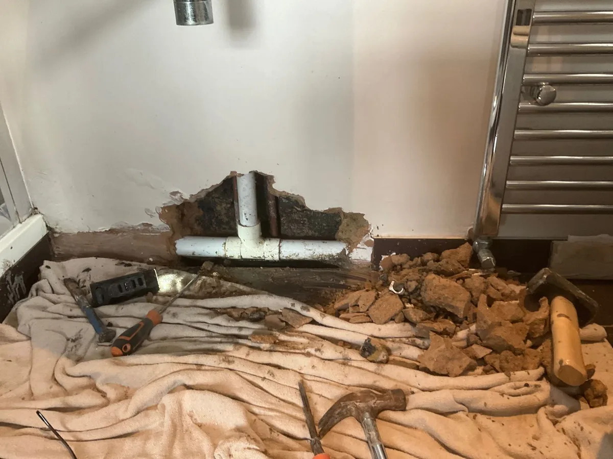 leak located at 15mm copper pipe exposed behind broken plaster in ensuite wall