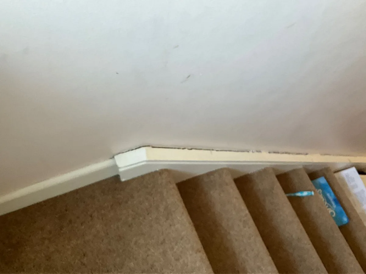 water stain on stair skirting board and wall before leak detection works