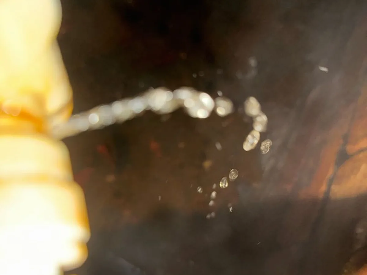 leak found at split connection fitting spraying water beneath suspended floor